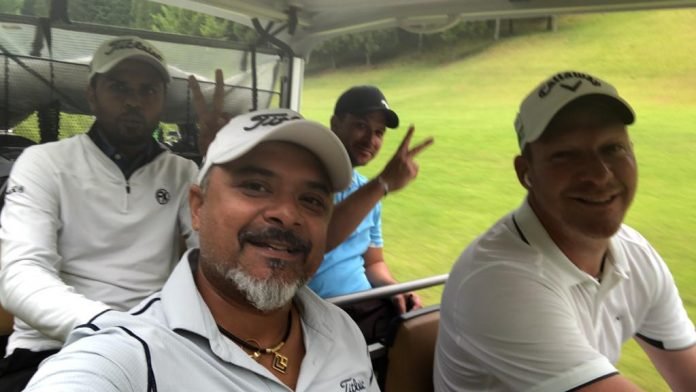 Rahil Gangjee (left) with Tour buddy Shaun Norris during a recent practice round at the Joyx Golf Club. Rahils's caddie Raghu is seated left in the back row.